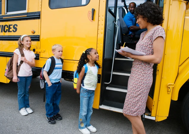 Kids getting on a school bus
